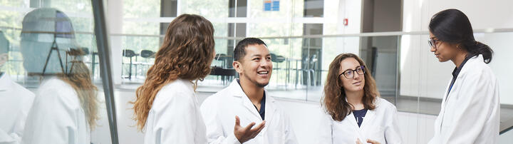Group of young scientists discussing on a staircase