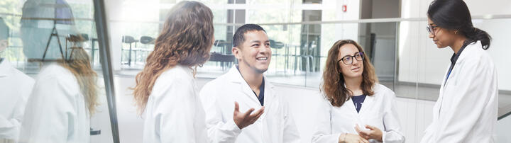 Group of young scientists discussing on a staircase