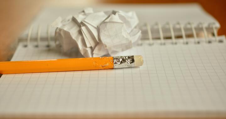 crumbled paper and pencil