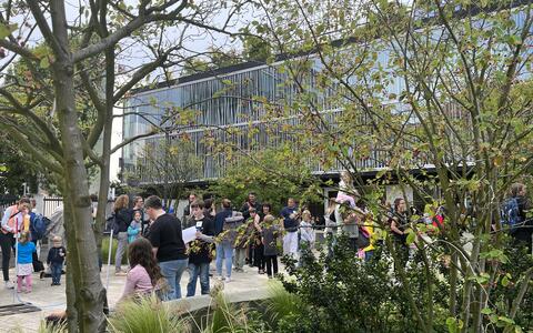 Many people in front of a research building