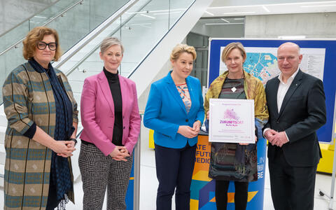 a group of people together with an award