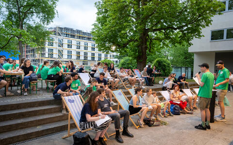 People at an open-air scientific lecture