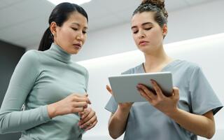 Two people are looking at a tablet