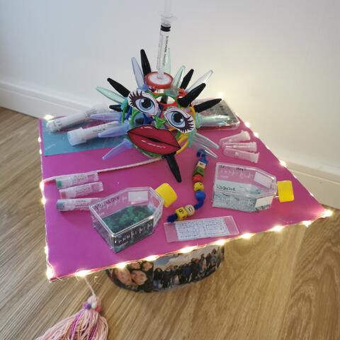Pink homemade doctor hat with creative accessories from the lab