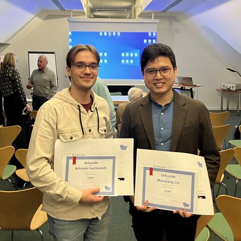 Artsemi Yushkevic and Manqiang Lin with their prizes.