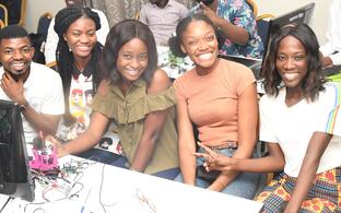 Group of people sitting around a table and facing the camera