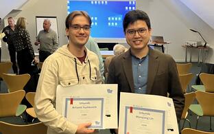 Artsemi Yushkevic and Manqiang Lin with their prizes.