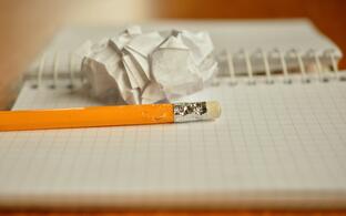 crumbled paper and pencil