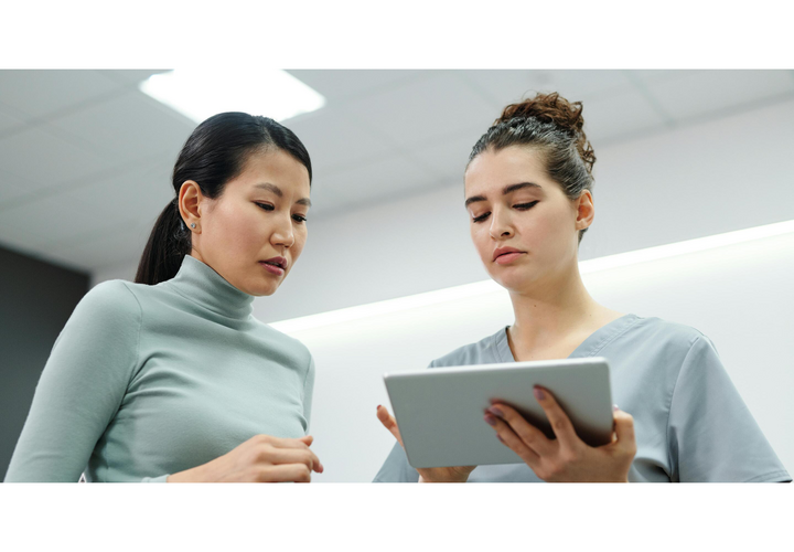 Two people are looking at a tablet