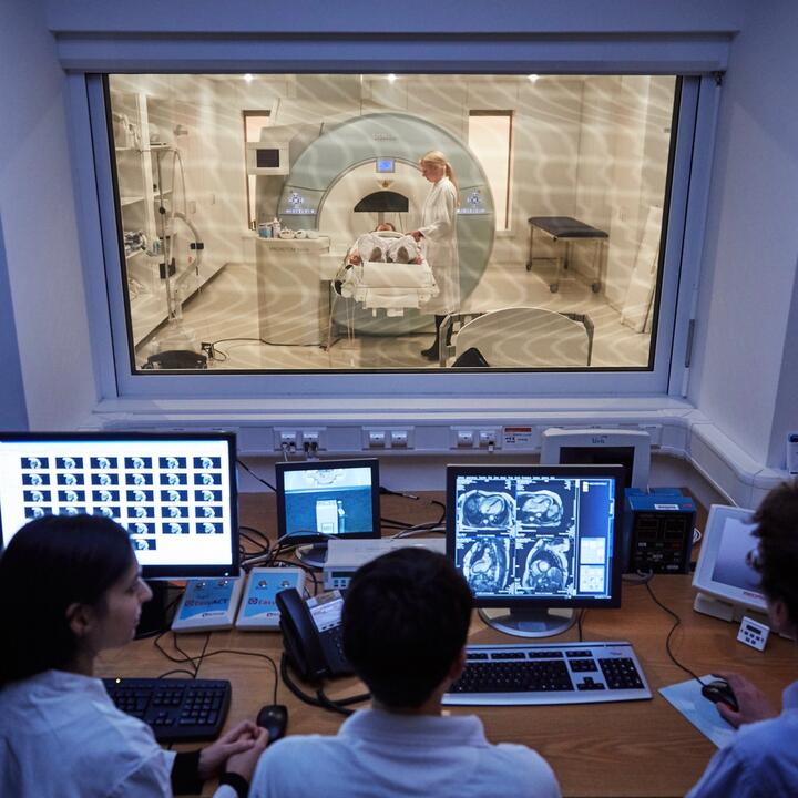MRI machine and people at computers