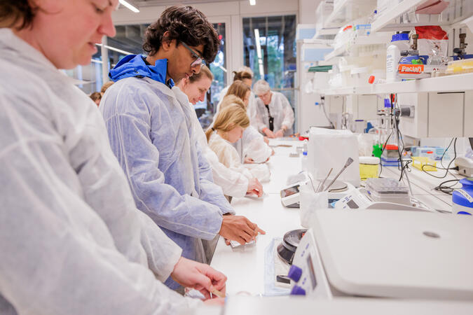 people at a bench in a lab