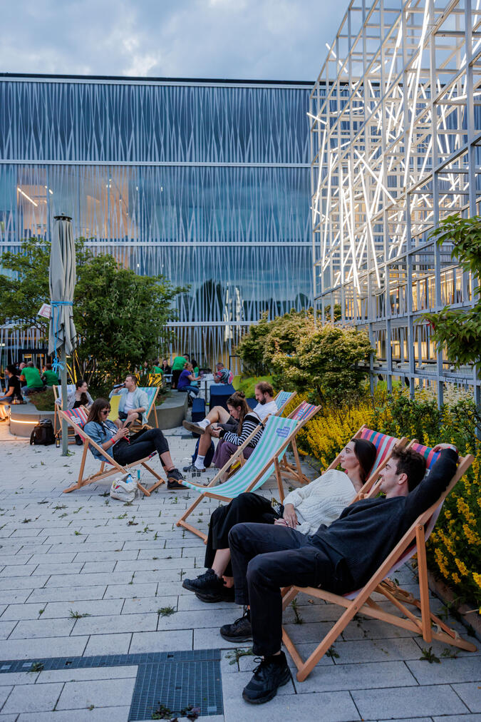 people on a rooftop terrace in the evening