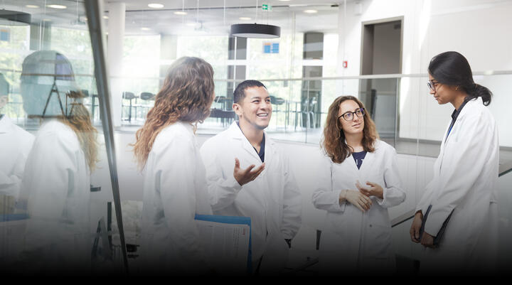 Group of young scientists discussing on a staircase