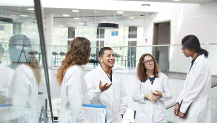 Group of young scientists discussing on a staircase